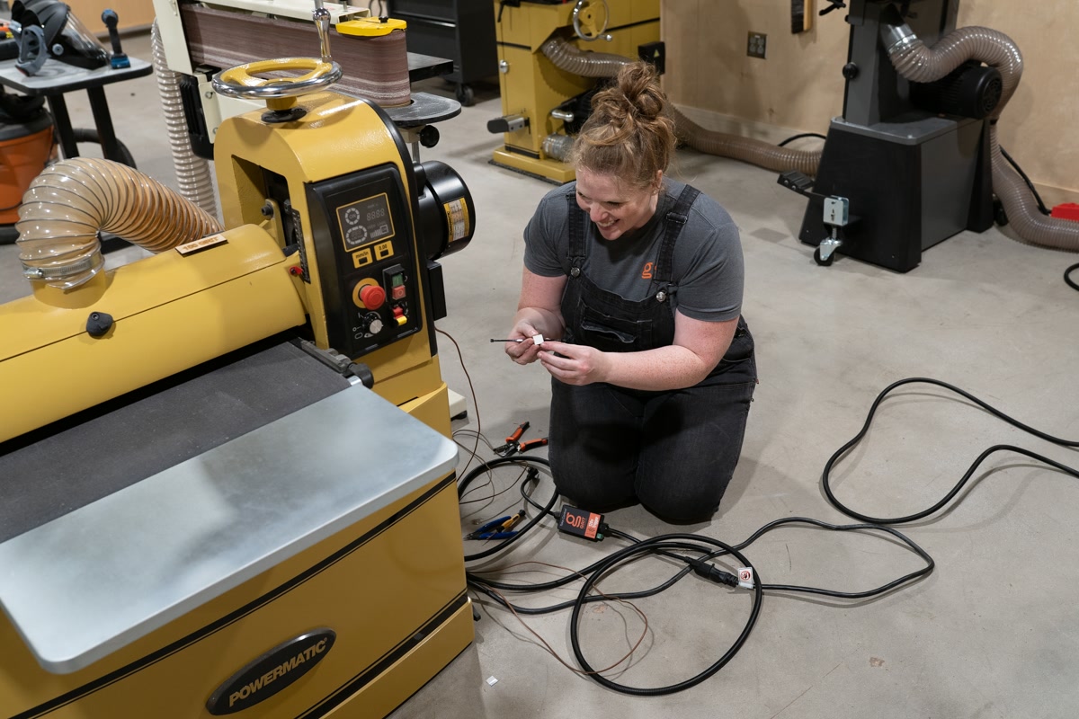 GRIT installer wiring a connected control on workshop equipment