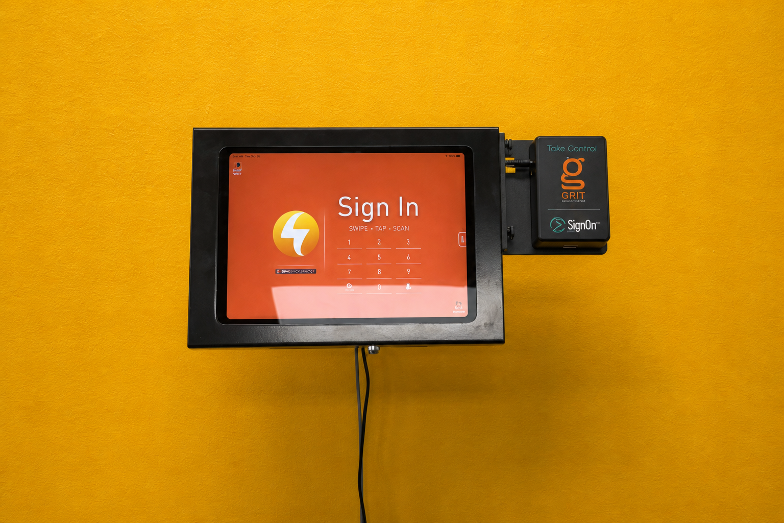 GRIT Track SignOn mounted on an orange wall